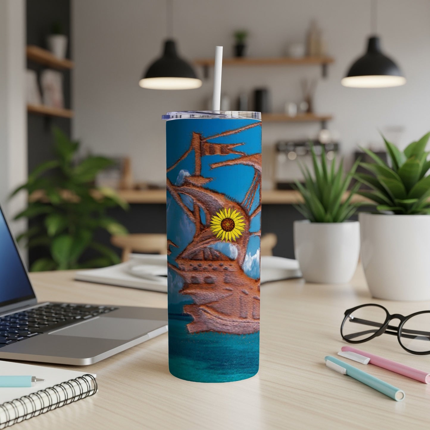 Tall tumbler with pirate ship and sunflower design.
