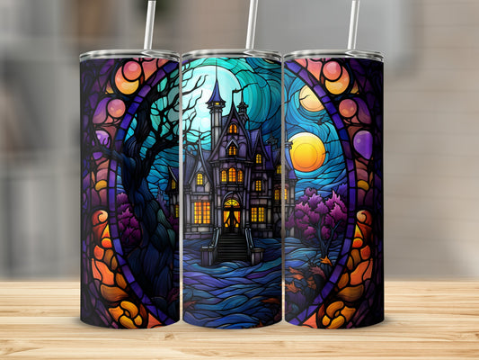 Stained glass tumbler with haunted house and moon design.