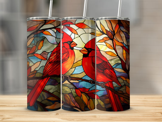 Two red cardinals perched on a branch, stained glass design.