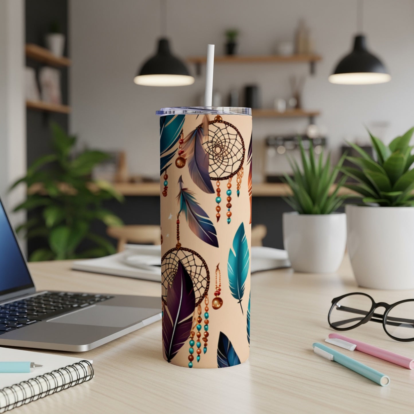 Beige tumbler with dream catcher and feather pattern, straw inserted.