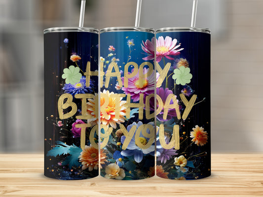 Tumbler with "Happy Birthday to You" surrounded by vibrant flowers on a dark background.