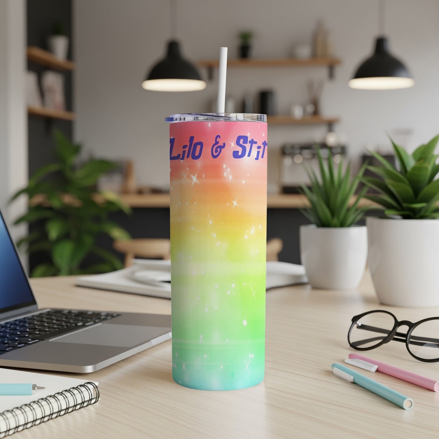 Lilo & Stitch tumbler with rainbow gradient and straw, on a desk.