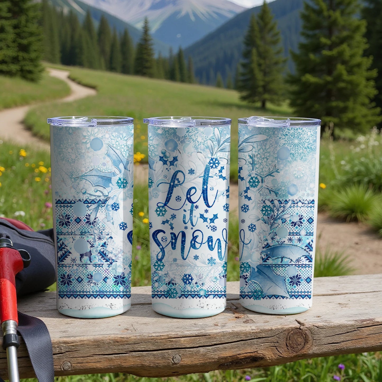 Three snow-themed tumblers with "Let it Snow" text on a wooden surface.