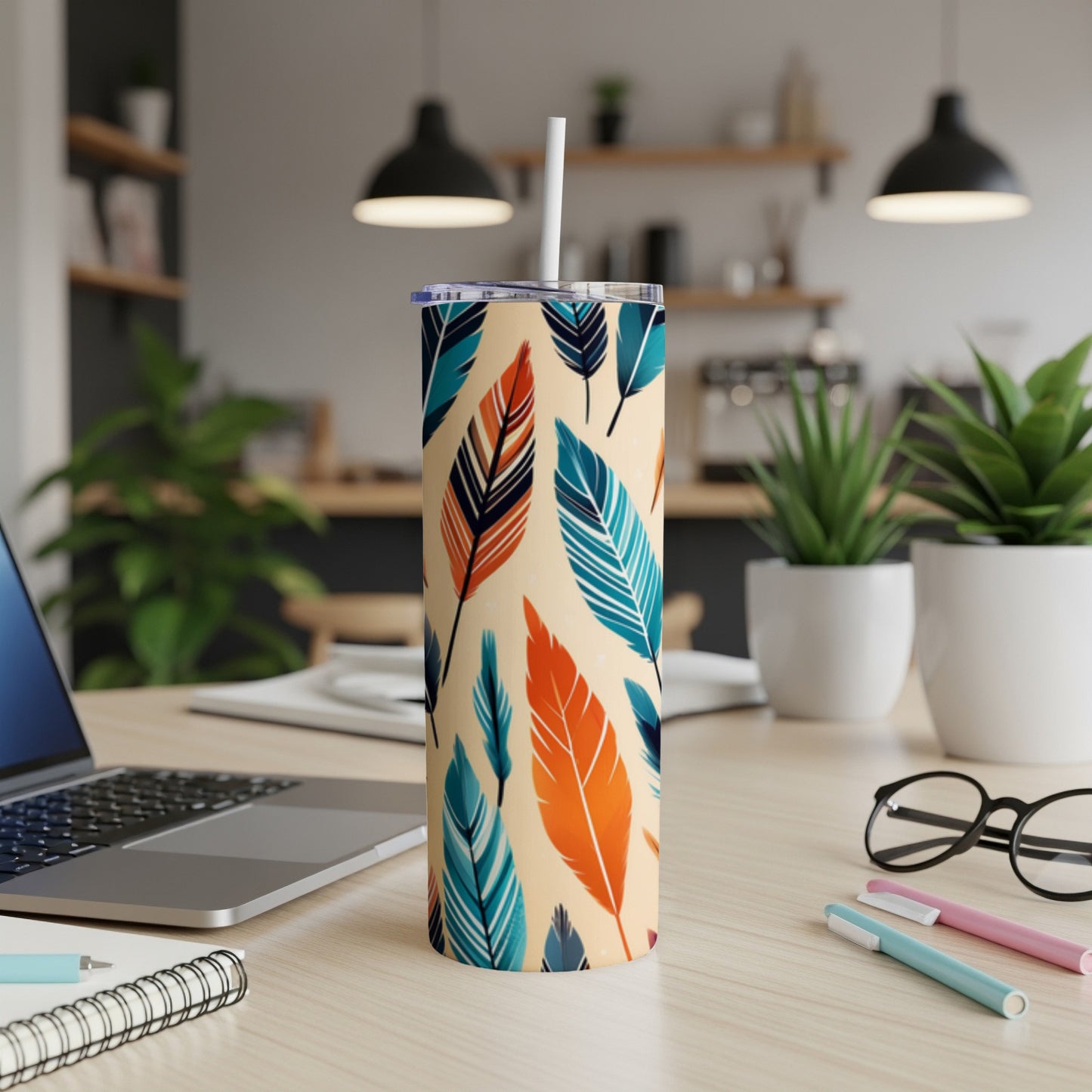 Beige tumbler with colorful feather pattern and white straw.