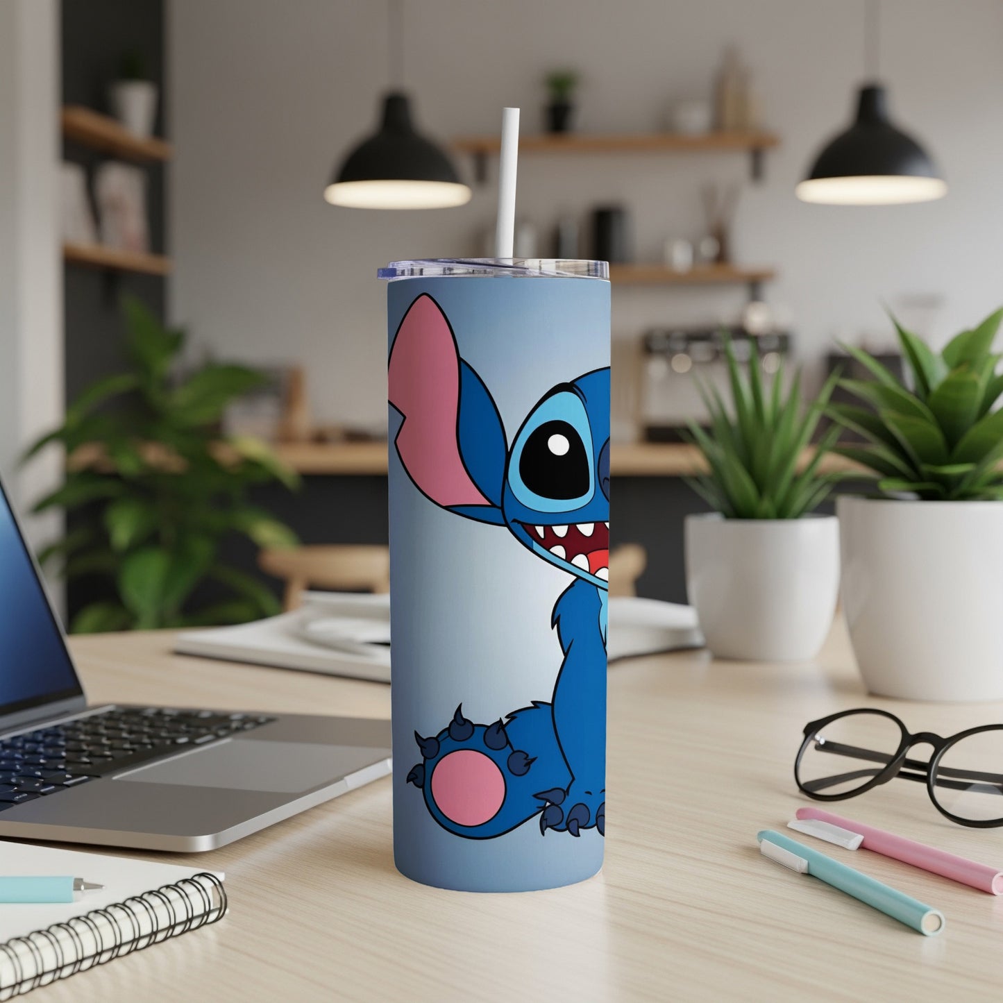 Blue Stitch character tumbler with straw on a desk.