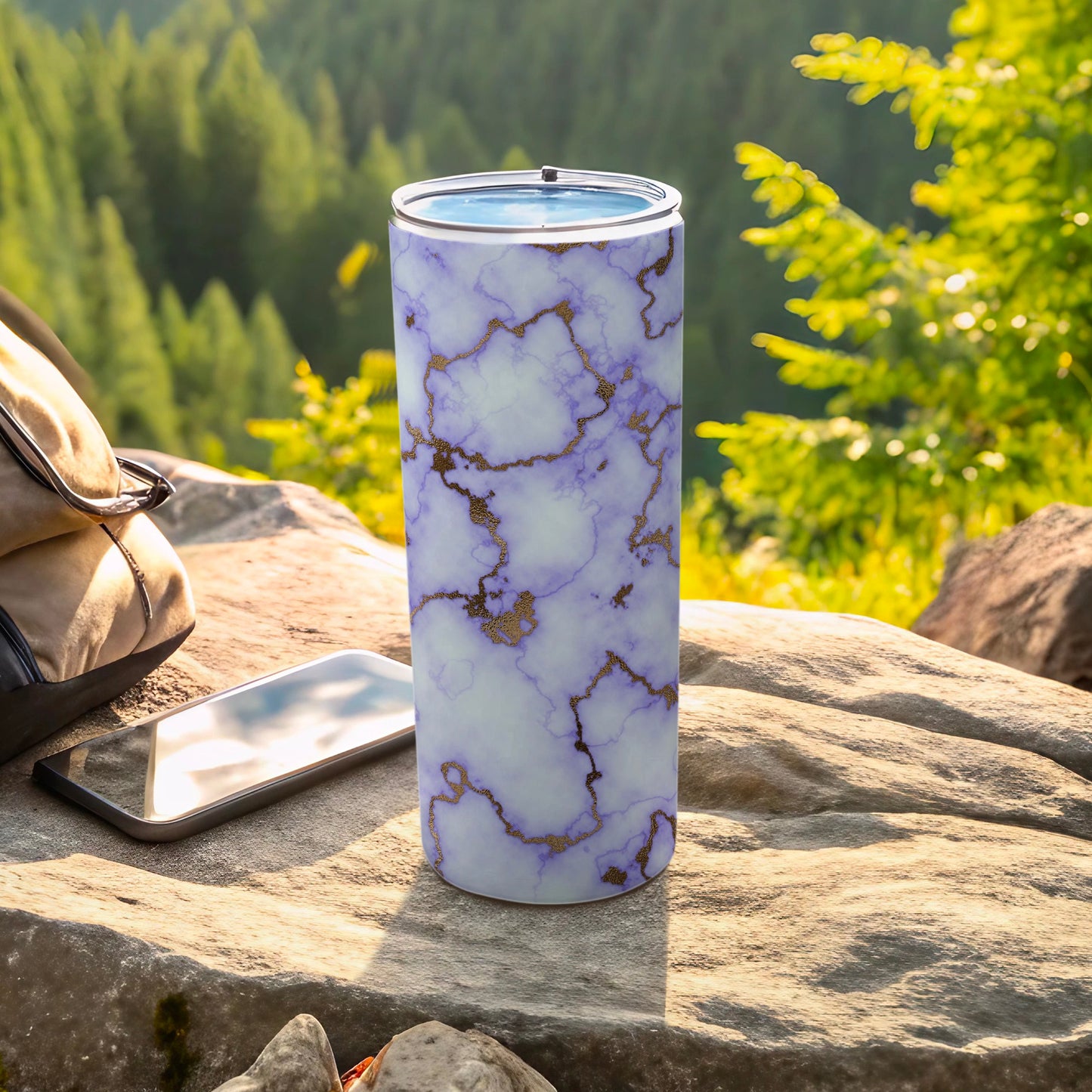 White marble tumbler with gold veins and a blue lid.