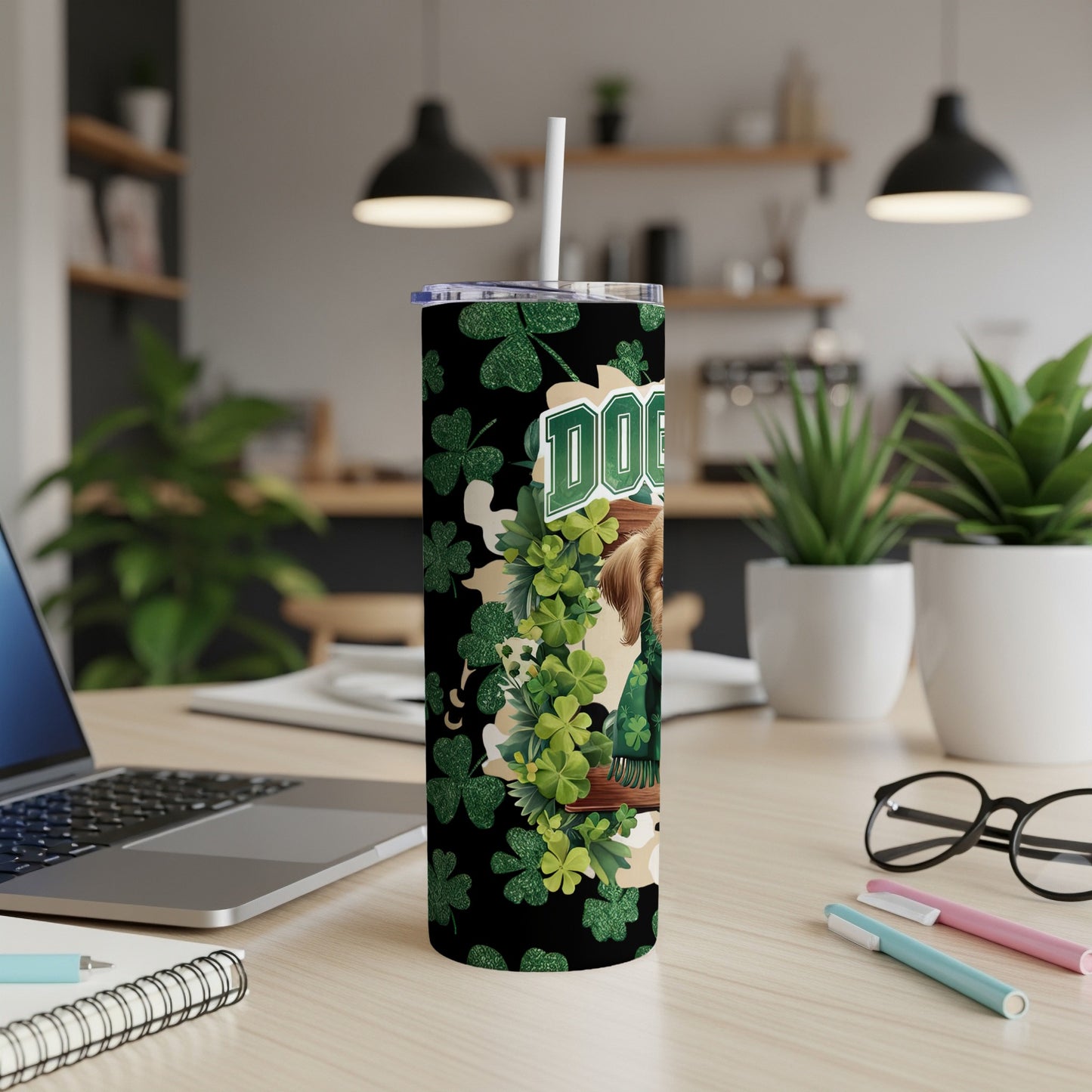Green shamrocks and a dog's face decorate a black tumbler with "DOG" text.