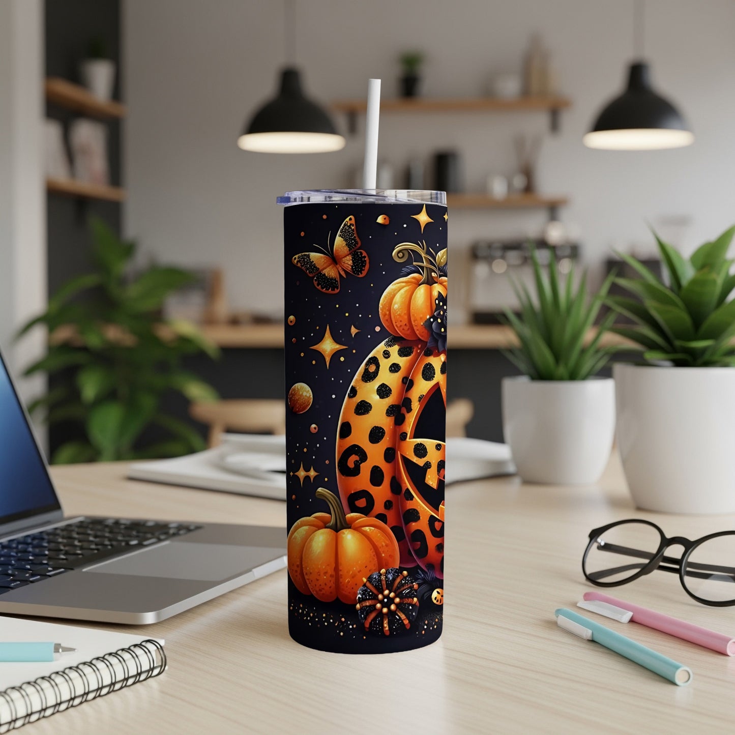 Tumbler with Halloween pumpkins, leopard print, and a butterfly on a dark background.