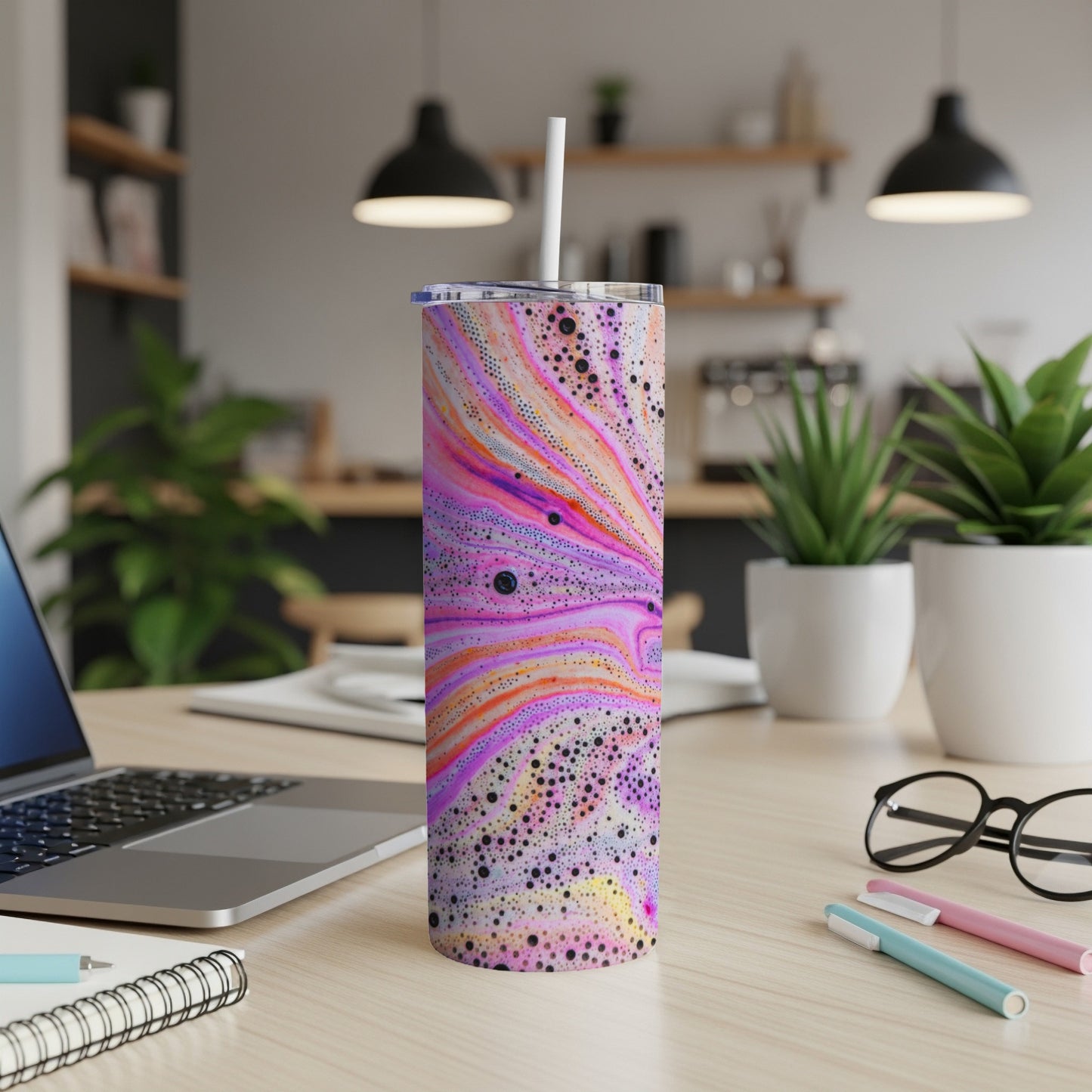 Tall tumbler with colorful swirling marble pattern and white straw.