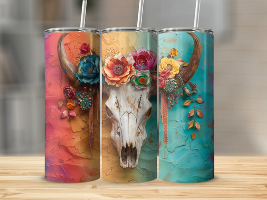 Three tumblers with floral-decorated cow skulls and textured backgrounds.