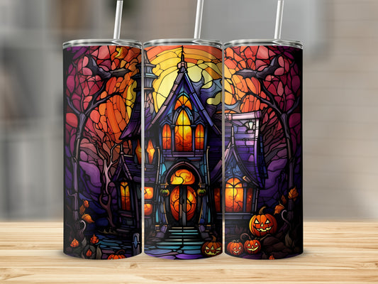 Stained glass haunted house with pumpkins and spooky trees, sunset sky.