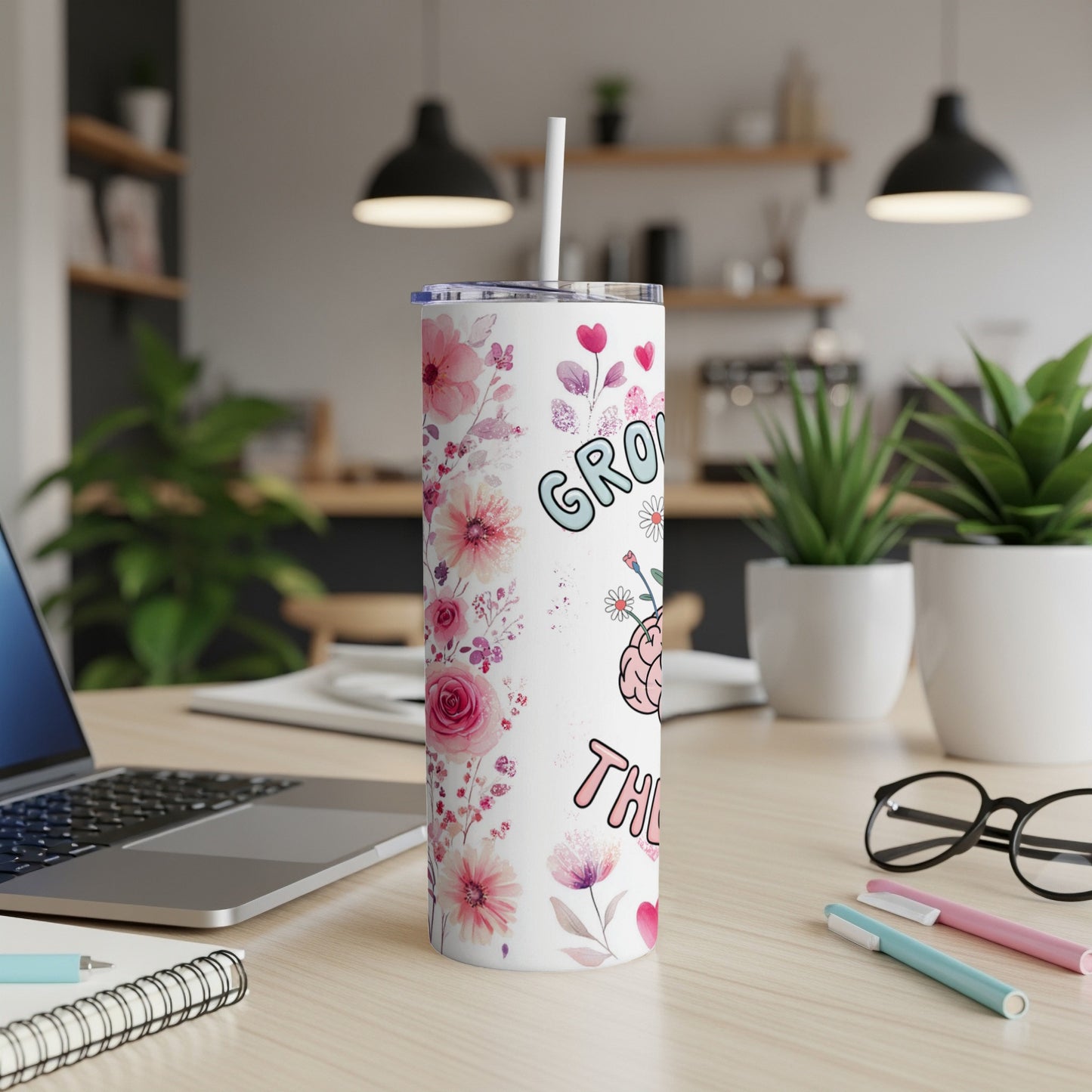 Tumbler with floral design and "Grandma the heart" text.