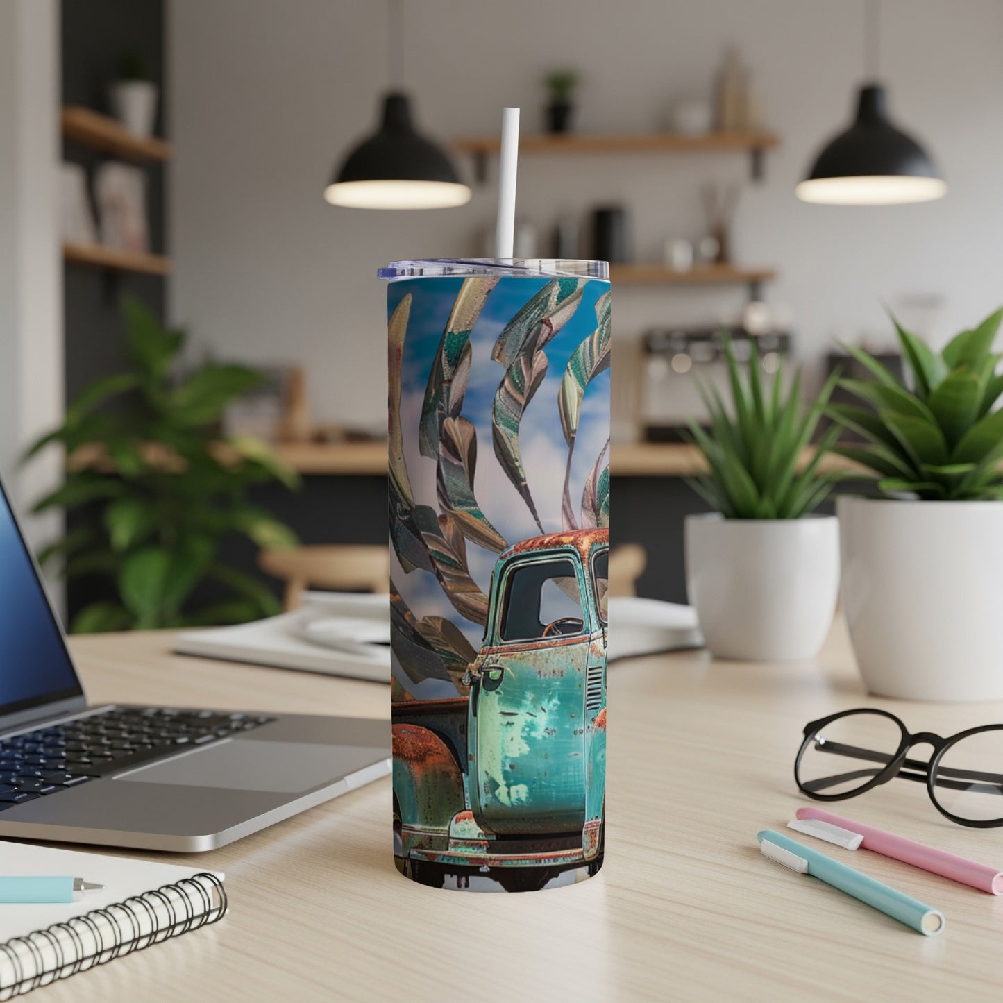 Turquoise vintage truck with swirling fabric pattern on a tumbler.