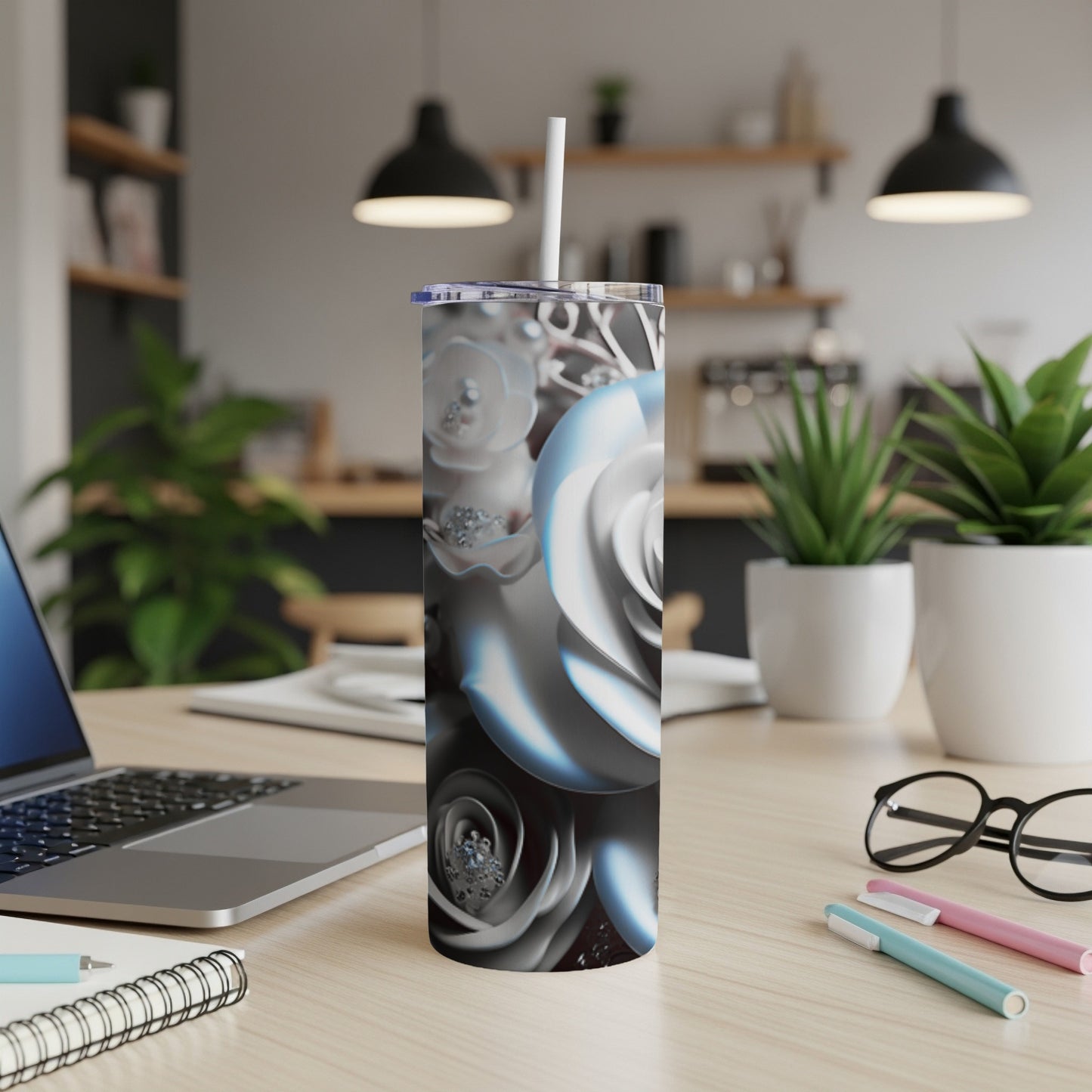 White rose floral pattern on a white tumbler with a straw.