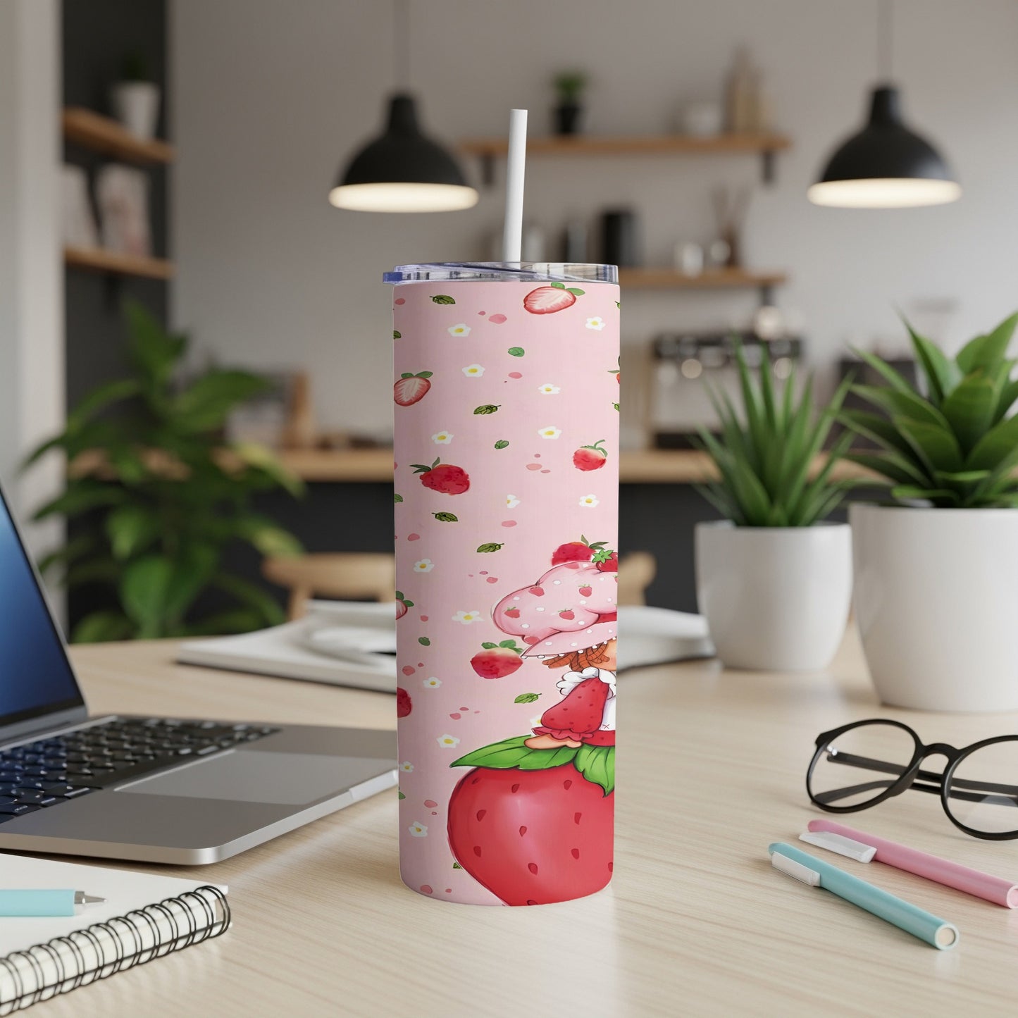Pink tumbler with cartoon strawberry character and repeating strawberry pattern.