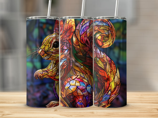 Squirrel design tumbler with stained glass effect, set against a blurred dark background.