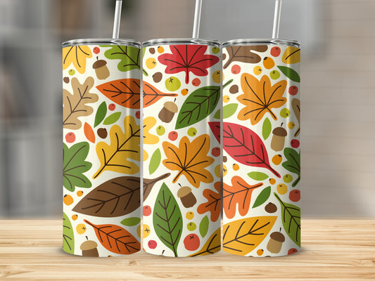 Three tumblers with fall leaf pattern on a wooden surface.