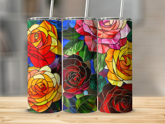 Three stained glass tumblers with colorful rose designs on a wooden surface.