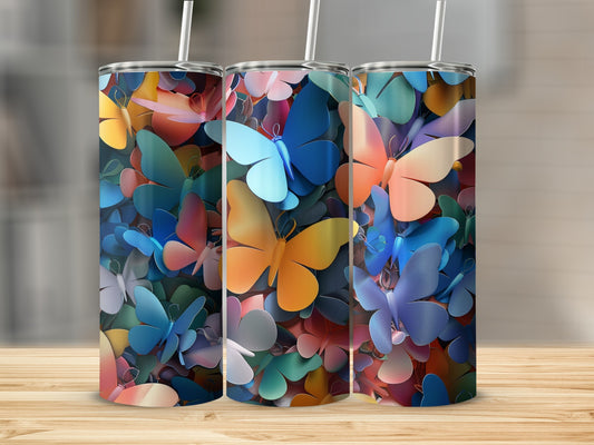Three tumblers with a colorful butterfly pattern displayed on a wooden surface.