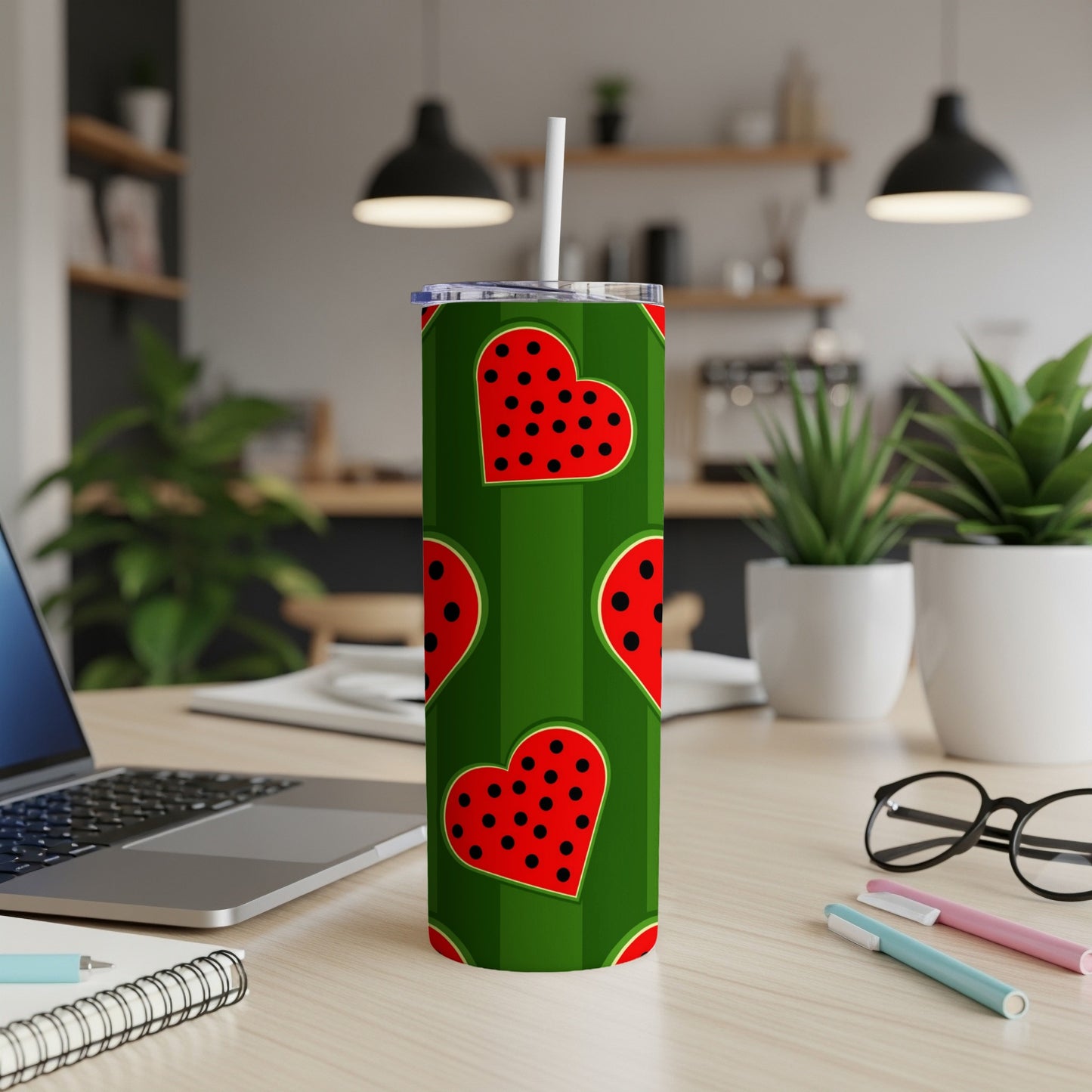 Green tumbler with red hearts and black polka dots, includes a straw.