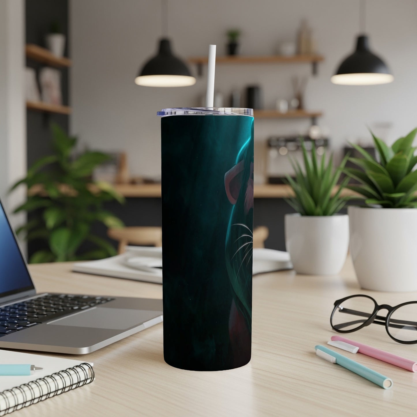 Black tumbler with teal glowing cyberpunk cat design on desk.