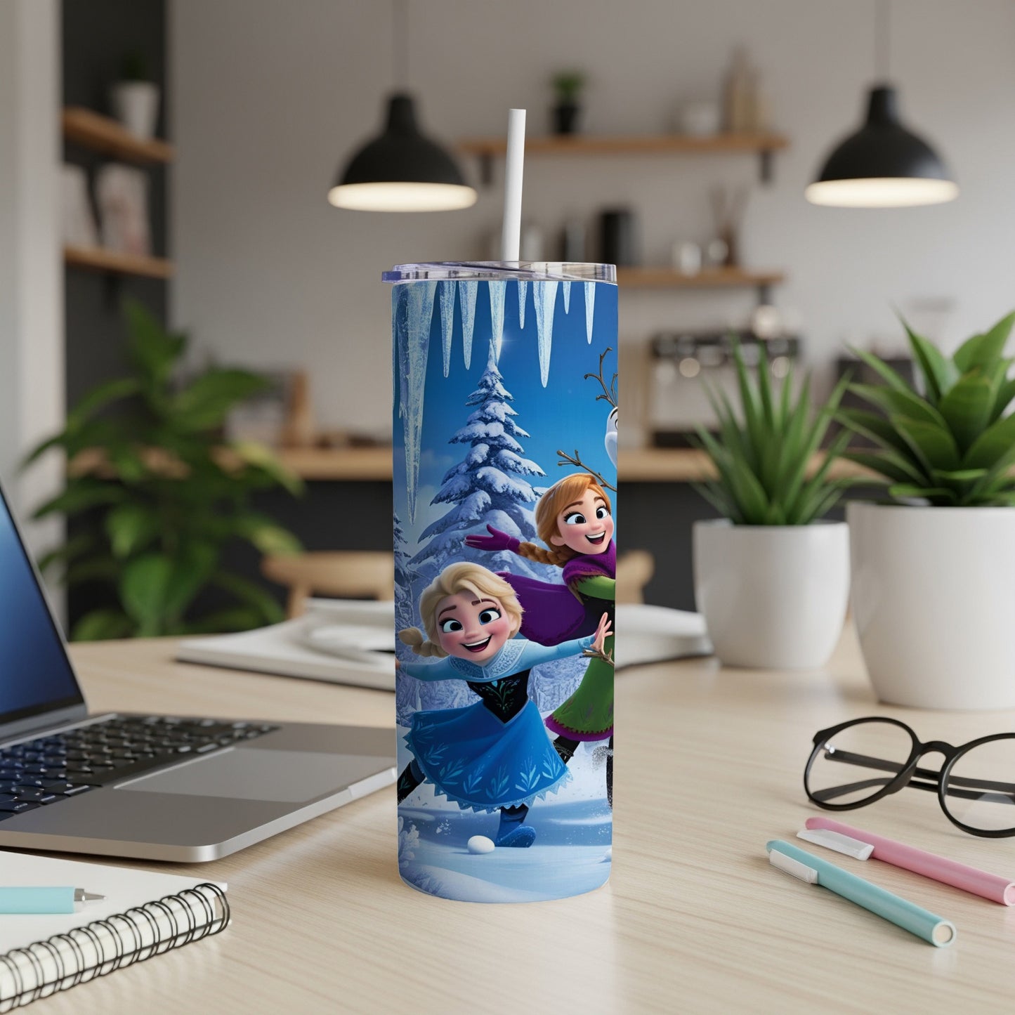 Anna and Elsa from Frozen ice skating with Olaf, on a blue speckled tumbler.