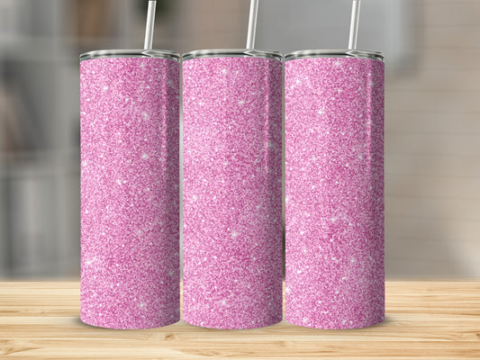 Three pink glitter tumblers with straws on a wooden surface.