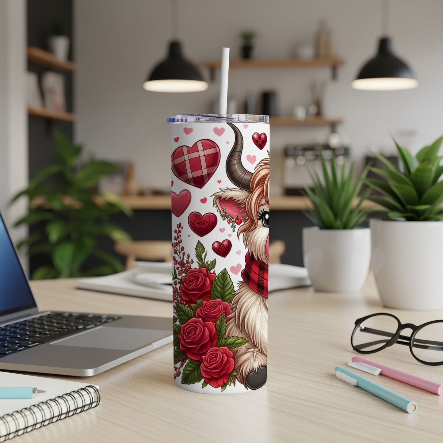 Cow with roses and hearts design on a white tumbler with straw.