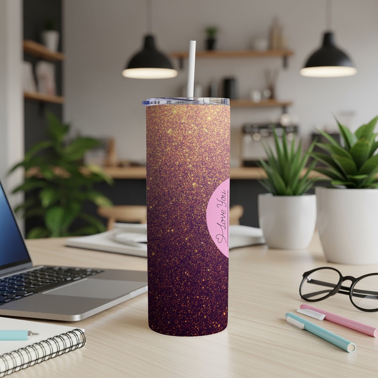 Glittery pink tumbler with "I Love You" text, angled on a desk.