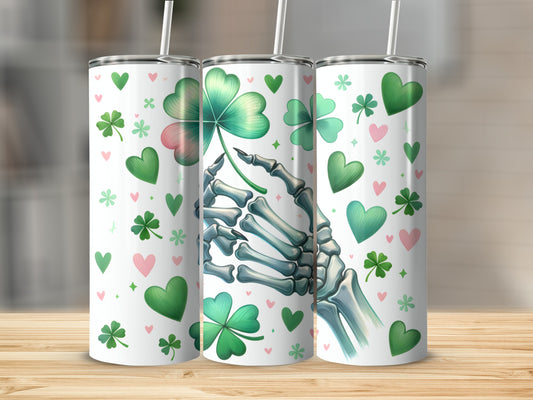 Skeleton hand holding a shamrock surrounded by hearts and shamrocks.