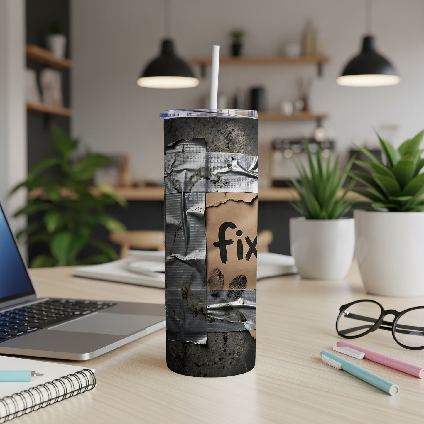 Tumbler with duct tape design and "fix" written on torn paper.