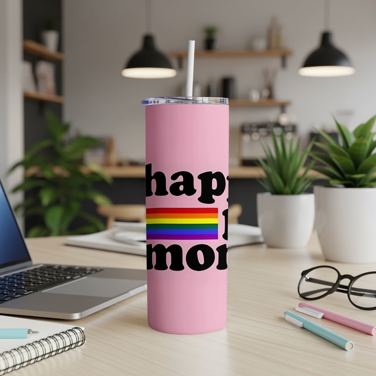 Pink tumbler with "happy pride" text and rainbow flag.