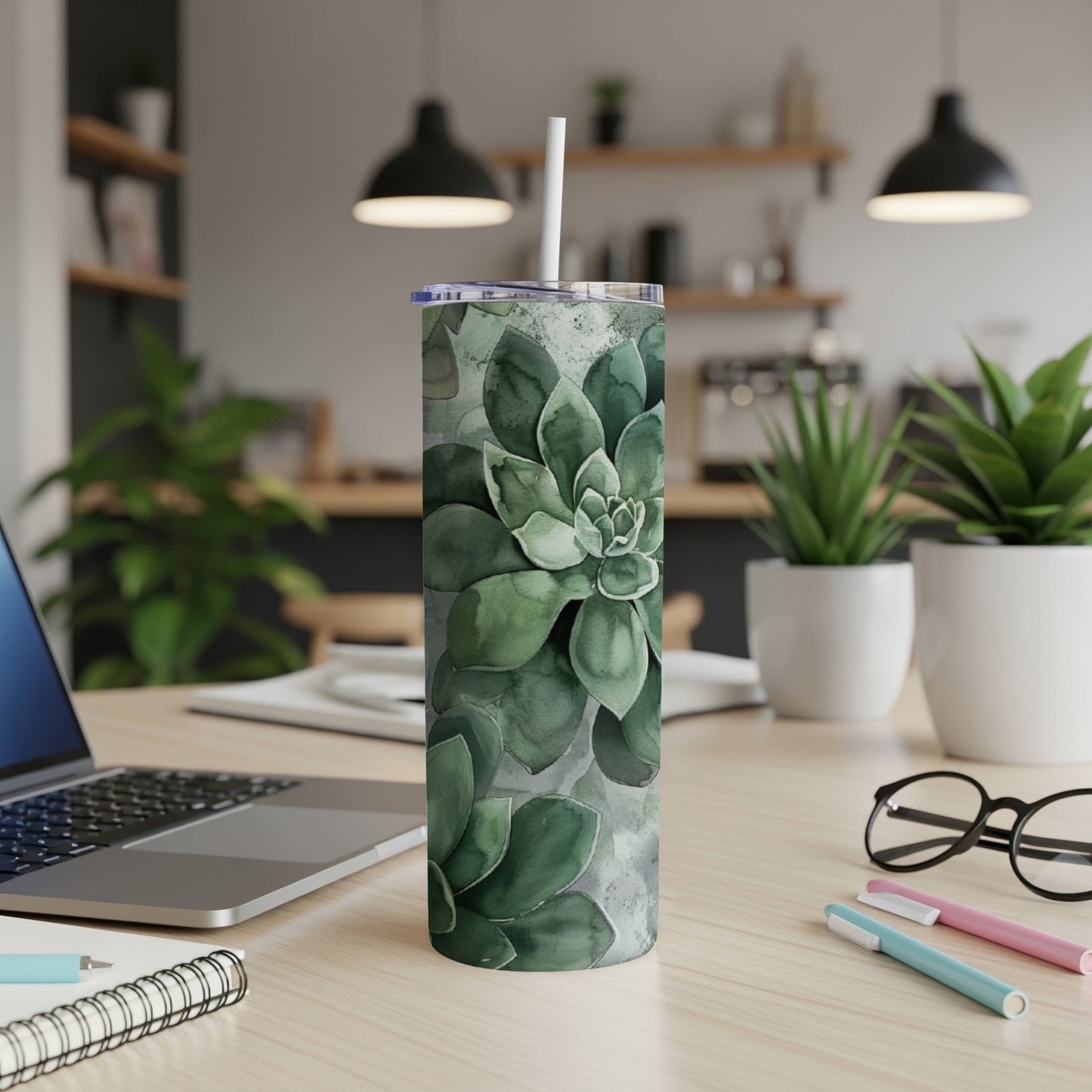 Green succulent plant pattern on a white stainless steel tumbler.