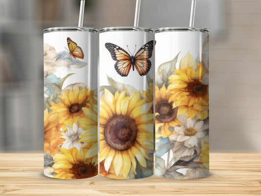 Three tumblers with sunflowers and butterflies, arranged on a wooden surface.