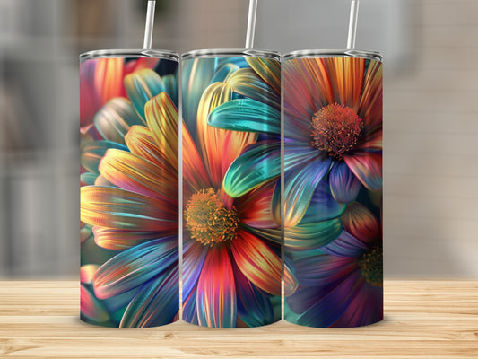 Three colorful floral tumblers with straws sit on a wooden surface.
