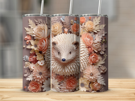 Hedgehog surrounded by peach and cream paper flowers on a brown tumbler.