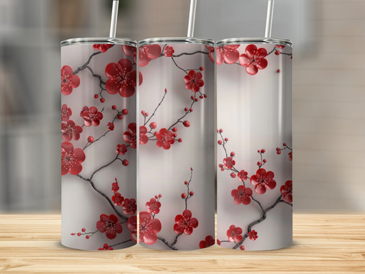 Three tall tumblers with red floral branches on a white background.