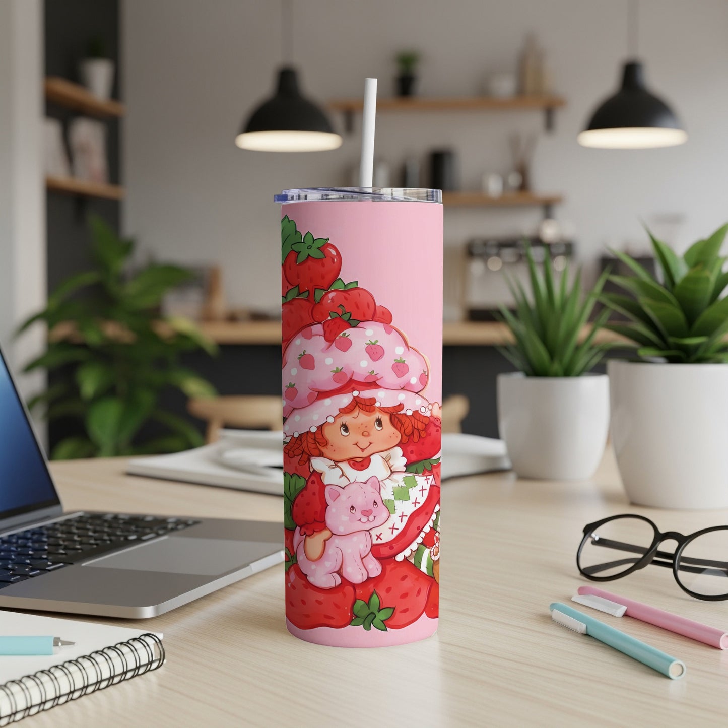 Pink tumbler with Strawberry Shortcake and a cat among strawberries.