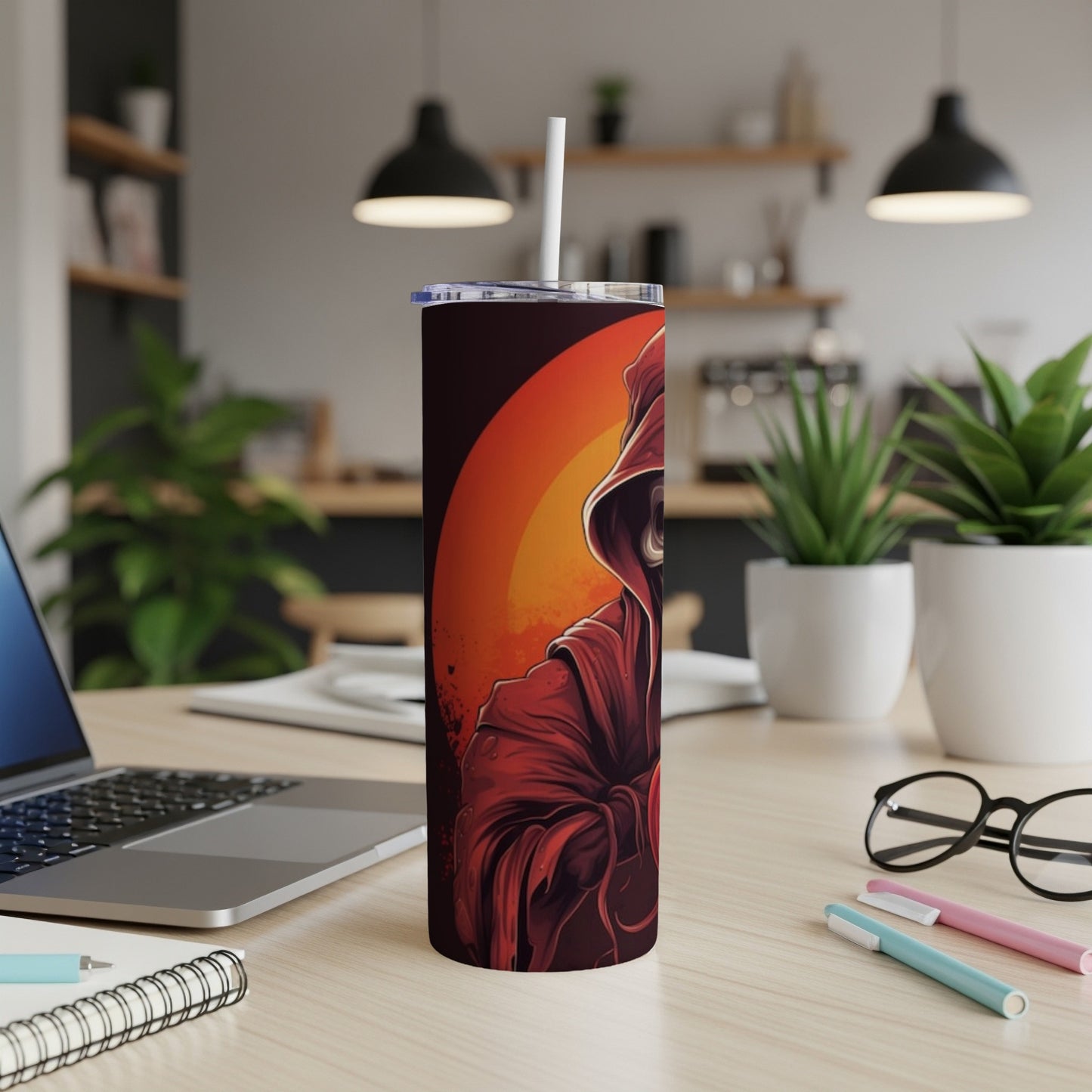 Tall tumbler with a hooded figure in red against an orange background.