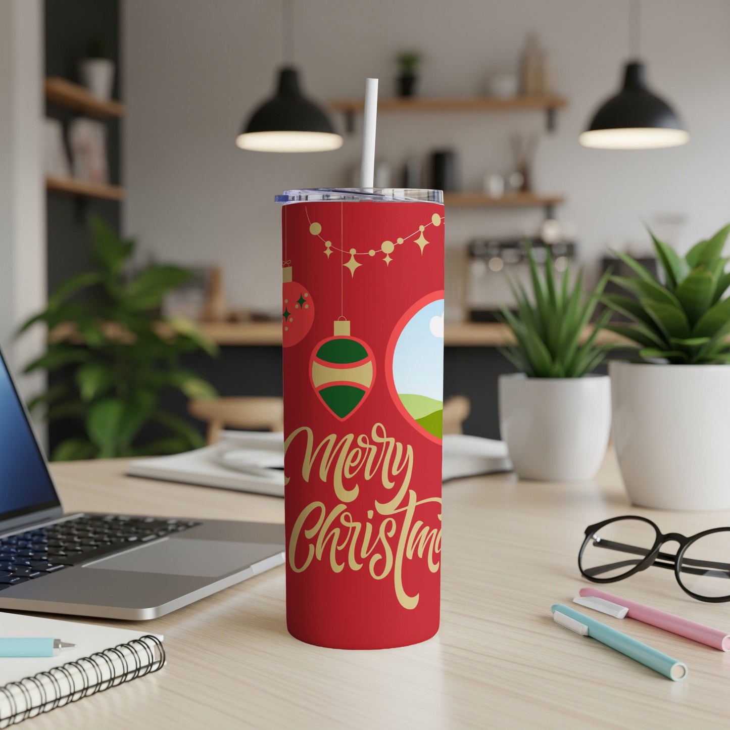 Red tumbler with gold "Merry Christmas" text and holiday ornaments.