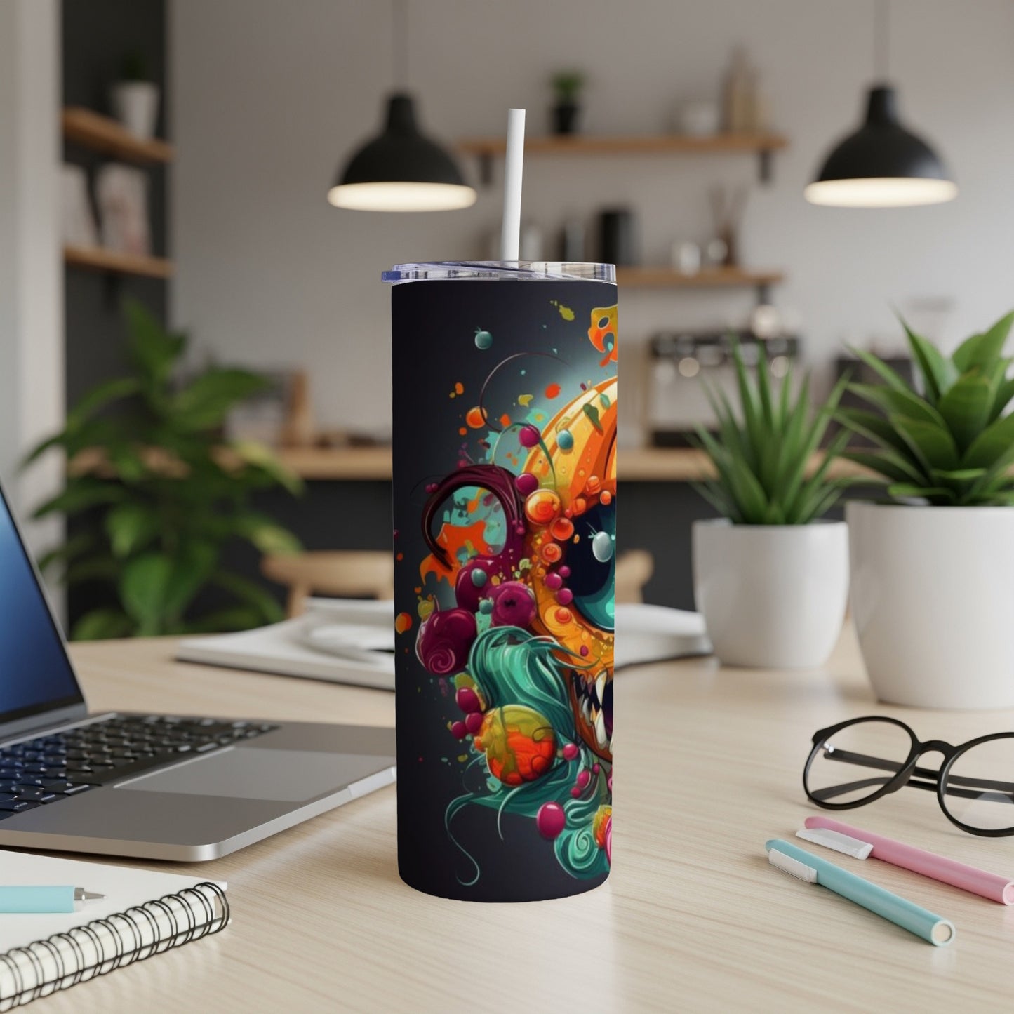 Tumbler with a vibrant, abstract monster design in orange, teal, and purple.