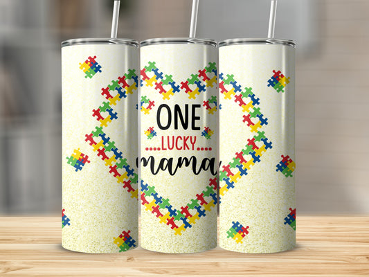 Tumbler with colorful puzzle pieces forming a heart and text "ONE LUCKY...mama...".