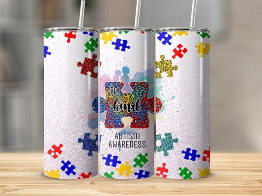 Tumbler with "Be Kind" and autism awareness puzzle pieces.