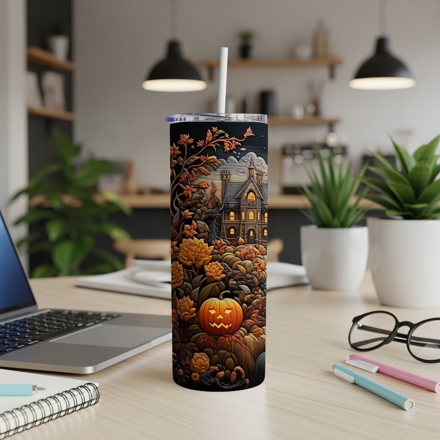 Tall tumbler with Halloween design of haunted house and jack-o'-lantern.