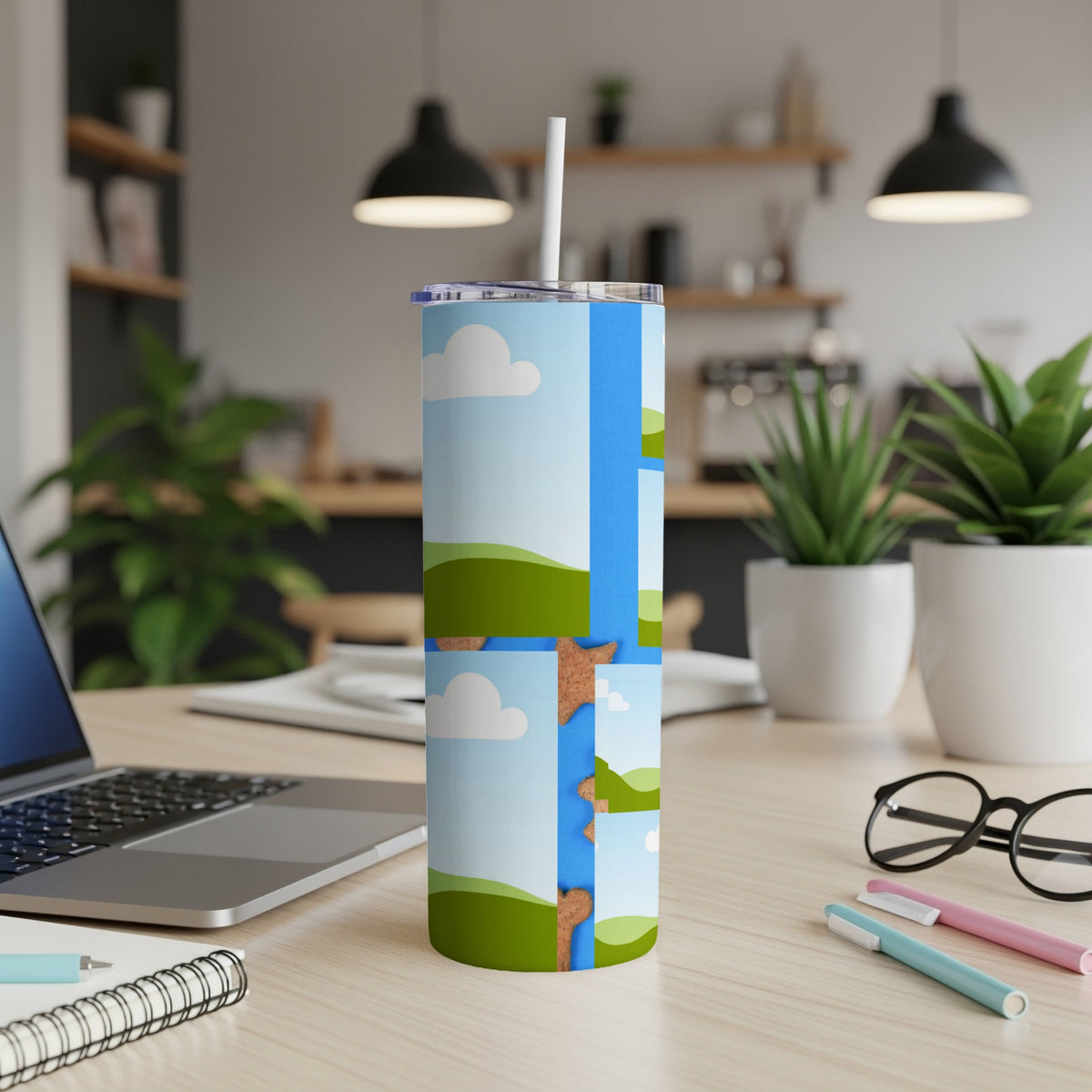 Tall tumbler with cartoon clouds, green hills, and blue sky design, with straw.