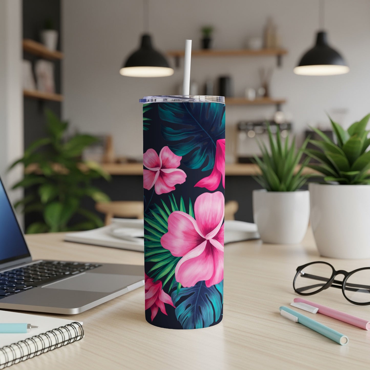 Dark tumbler with pink hibiscus and green palm leaves.