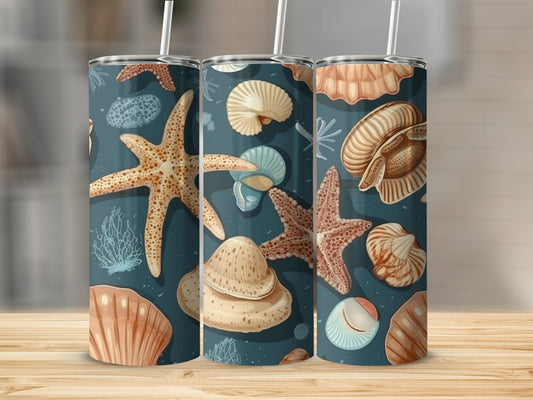 Three tumblers with seashell and starfish designs on a wooden surface.
