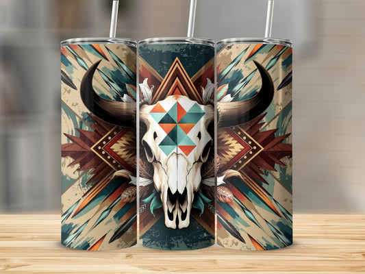 Cow skull with geometric patterns and feathers on a rustic background tumbler.