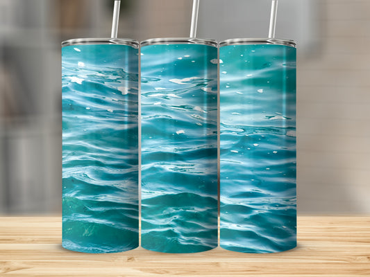 Three tumblers with a close-up of turquoise water and white foam.