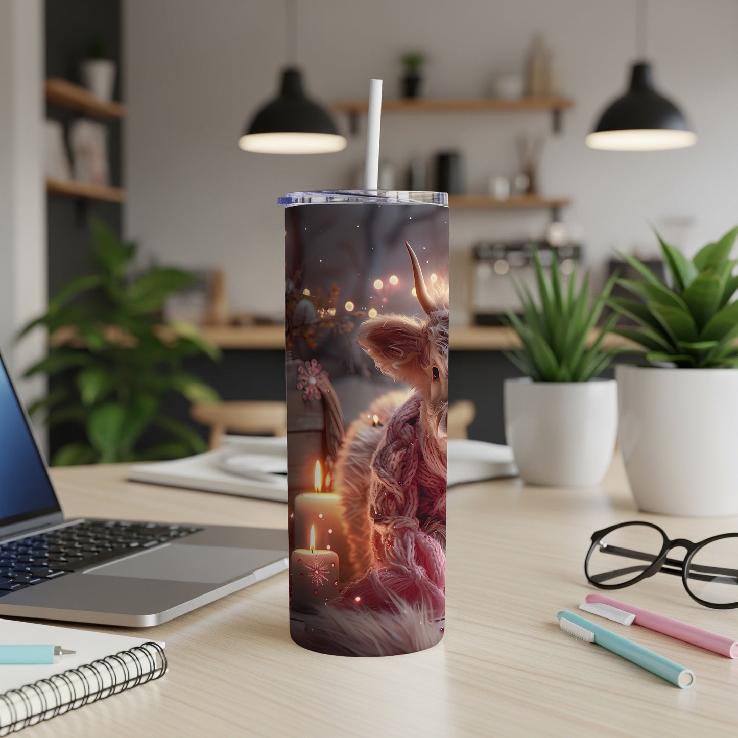 Highland cow illustration on a tumbler with candles and bokeh lights.